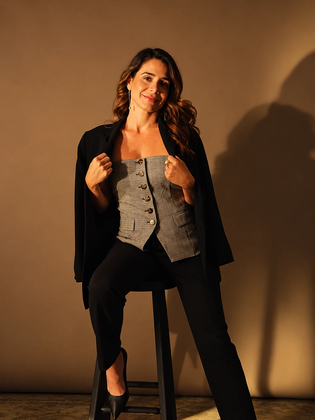 Dra. Raquel Botelho, sentada, de blazer preto